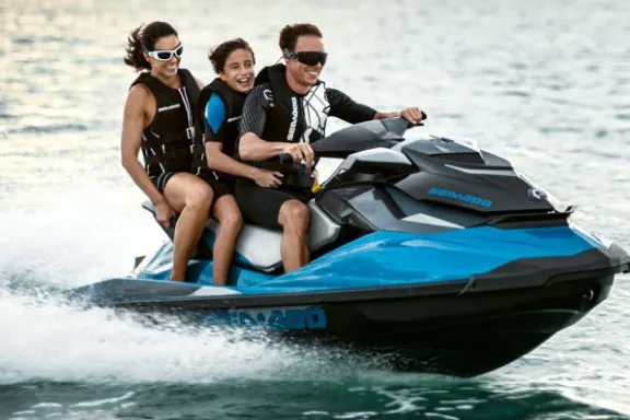 a person riding on the back of a boat in the water